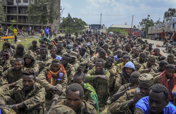 FILE - Captured Ethiopian government soldiers and allied militia members sit in rows after being paraded by Tigray forces through the streets in open-top trucks, as they arrived to be taken to a deten ...