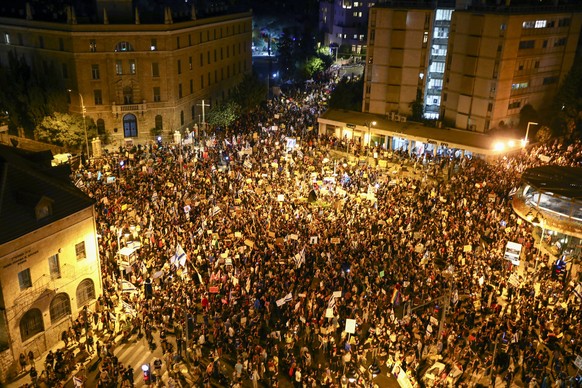 Thousands of protesters chant slogans and hold signs during a protest against Israel&#039;s Prime Minister Benjamin Netanyahu outside his residence in Jerusalem, Saturday, Aug 1, 2020. Protesters dema ...