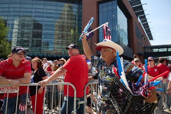 epa11489543 People line up to see Republican presidential nominee Donald J. Trump and Republican vice presidential nominee Senator JD Vance at their first joint campaign rally at Van Andel Arena in Gr ...