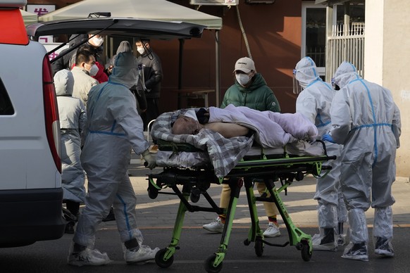 An elderly man on a stretcher is wheeled into the fever clinic at a hospital in Beijing, Friday, Dec. 9, 2022. China began implementing a more relaxed version of its strict &quot;zero COVID&quot; poli ...