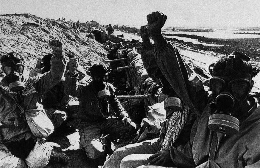 FILE - In this Friday Jan. 16, 1987 file photo, Iranian soldiers wear gas masks near a canal in the Shalamcheh area, southeast of Basra, Iraq. Iraqi dictator Saddam Hussein was accused of using mustar ...