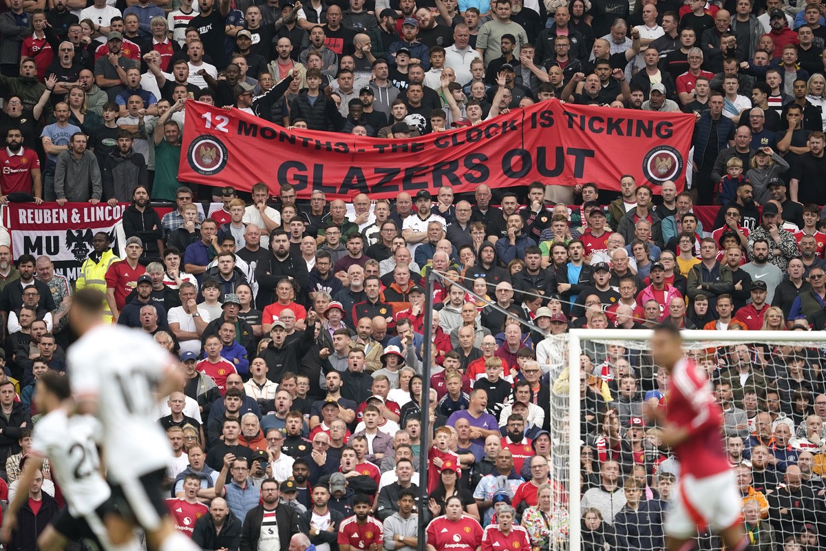 A banner writing ' Glazers out' is displayed by spectators during the English Premier League soccer match between Manchester United and Liverpool at Old Trafford, Sunday, Sept. 1, 2024, in M ...