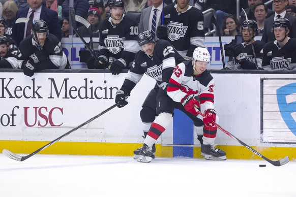 New Jersey Devils left wing Jesper Bratt, right, and Los Angeles Kings left wing Kevin Fiala vie for the puck during the second period of an NHL hockey game, Wednesday, Jan. 1, 2025, in Los Angeles. ( ...