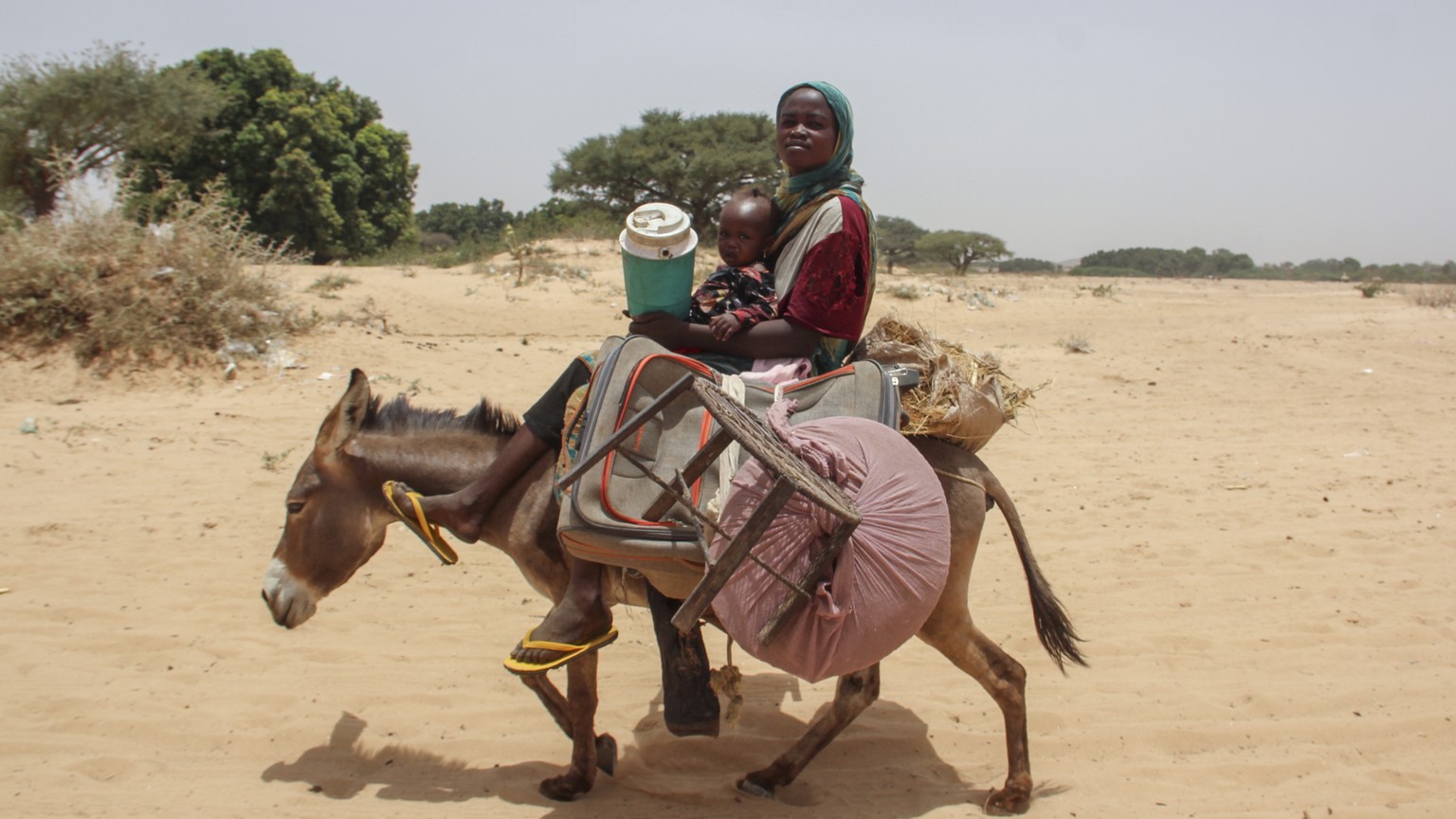 In this photo provided by UNICEF, refugees fleeing the conflict in Sudan arrive in the village of Koufroun, near the border between Chad and Sudan, in Chad on Thursday, April 27, 2023. Massive explosions and shootings…