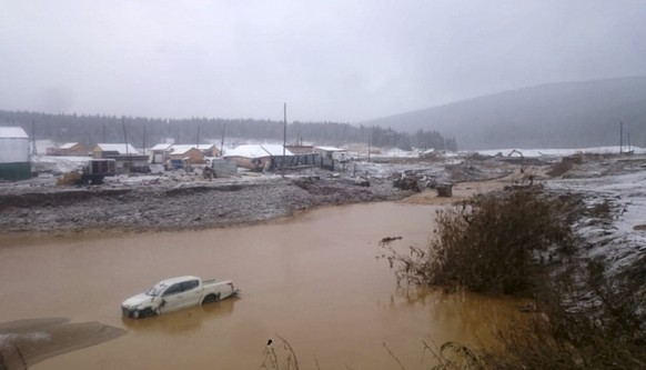In this image made from video provided by Russian Emergency Situations Ministry press service, a view after the collapse during heavy rain occurred early Saturday near the village of Shchetinkino, in  ...