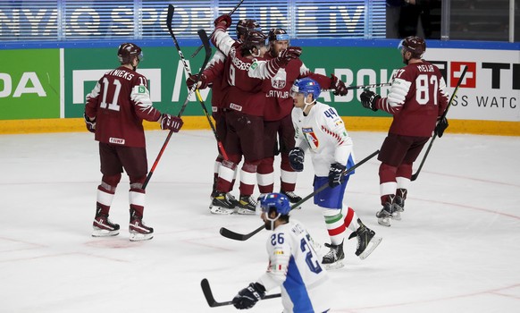 epa09225277 Players of Latvia celebrate a goal during the IIHF 2021 World Ice Hockey Championships group B match between Latvia and Italy at the Arena Riga, Latvia, 24 May 2021. EPA/TOMS KALNINS
