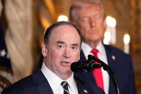 FILE - Secretary of the Navy John Phelan speaks, as President Donald Trump listens, at Trump's Mar-a-Lago club, Dec. 22, 2025, in Palm Beach, Fla. (AP Photo/Alex Brandon, file)
Donald Trump,John  ...