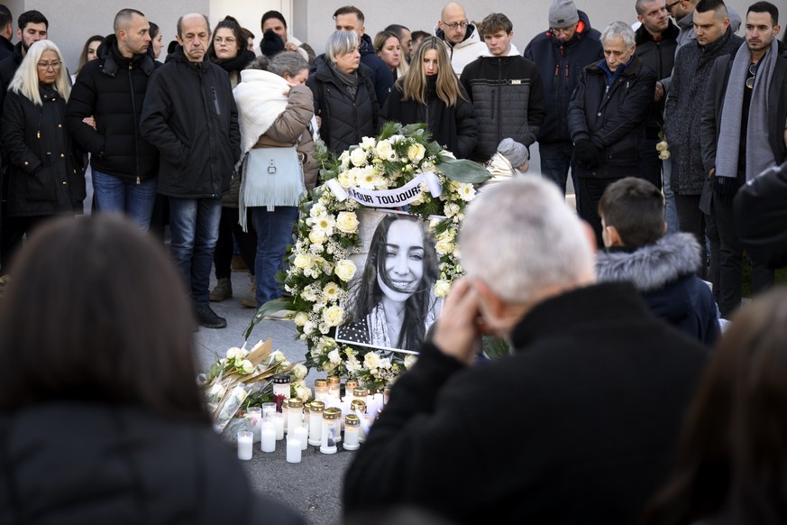People lay flowers in front of the home of one of the victims after a &quot;Marche Blanche&quot; (White March) to pay tribute for the victims of the 11 December shooting, in Sion, Switzerland, Saturda ...
