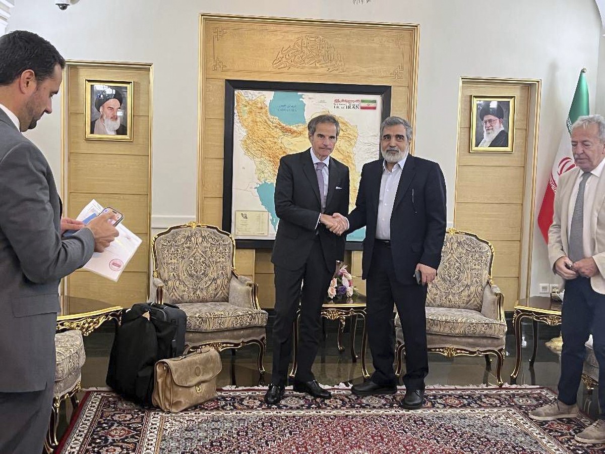 In this photo released by the Atomic Energy Organisation of Iran, International Atomic Energy Agency (IAEA) Director General, Rafael Mariano Grossi, left, shakes hands with deputy chief of Atomic Ener ...