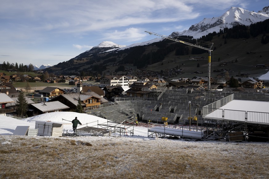 A man builds a platform in the finish area under construction of the Alpine Skiing FIS Ski World Cup, at Adelboden, Switzerland, Wednesday, December 28, 2022. The alpine skiing World Cup men&#039;s ra ...