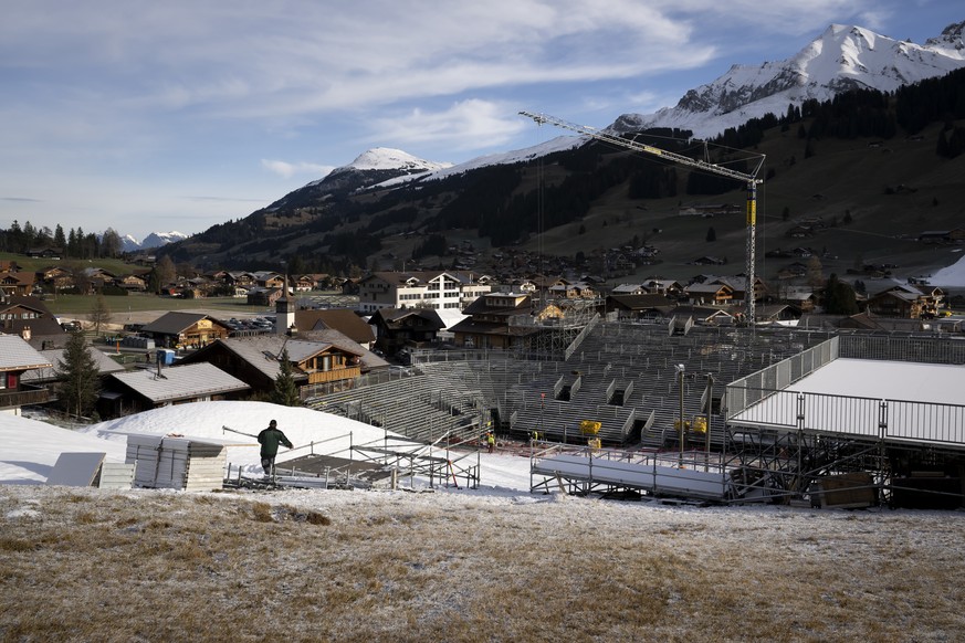 A man builds a platform in the finish area under construction of the Alpine Skiing FIS Ski World Cup, at Adelboden, Switzerland, Wednesday, December 28, 2022. The alpine skiing World Cup men's ra ...