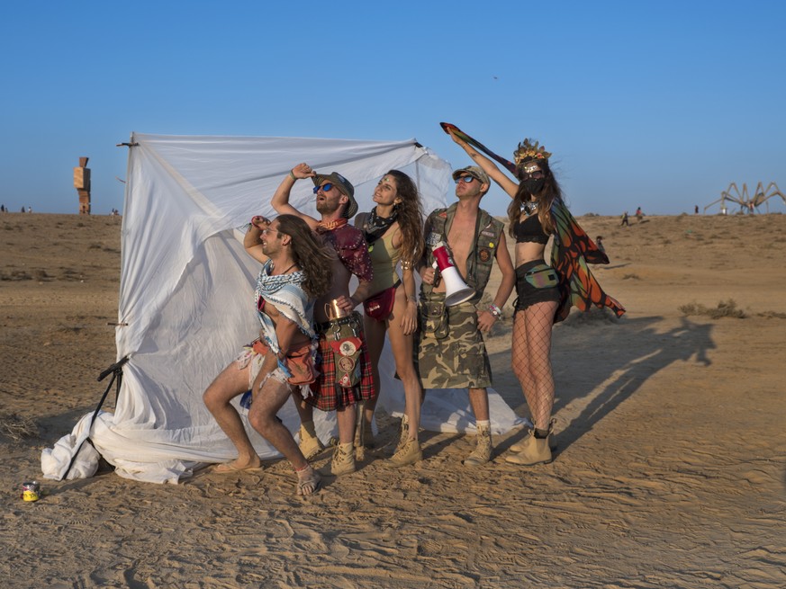 epa06740325 A group of &#039;burner&#039; friends pose in the Israeli MidBurn 2018 festival, near Sde Boqer in the Negev Desert in southern Israel, 15 May 2018. The festival is drawing thousands of &# ...