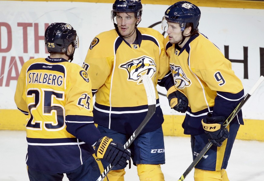 Nashville Predators defenseman Roman Josi (59), of Switzerland, is congratulated by Viktor Stalberg (25), of Sweden, and Filip Forsberg (9), of Sweden, after Josi scored a goal against the Minnesota W ...