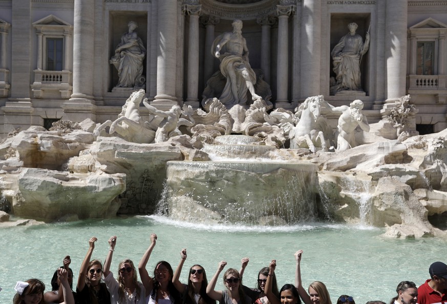 Tourists throw their coins in the Trevi Fountain in Rome, Wednesday, June 7, 2017. Police in Rome say they have arrested a man who allegedly shot smartphone videos of women&#039;s panties, preying on  ...