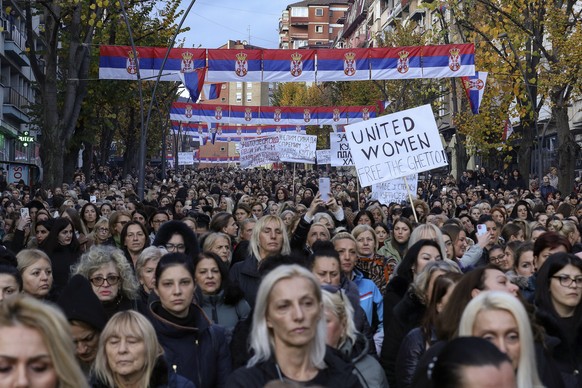 Women hold Serbia&#039;s flag as they march in the northern part of Kosovska Mitrovica, Kosovo, Wednesday, Nov. 23, 2022. Serbs in the northern part of Kosovska Mitrovica protested against planned fin ...