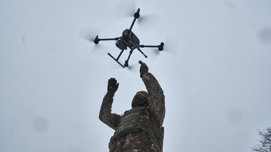 A Ukrainian soldier launches a drone close to the frontline near Avdiivka, Donetsk region, Ukraine, Friday, Feb. 17, 2023. (AP Photo/Libkos)