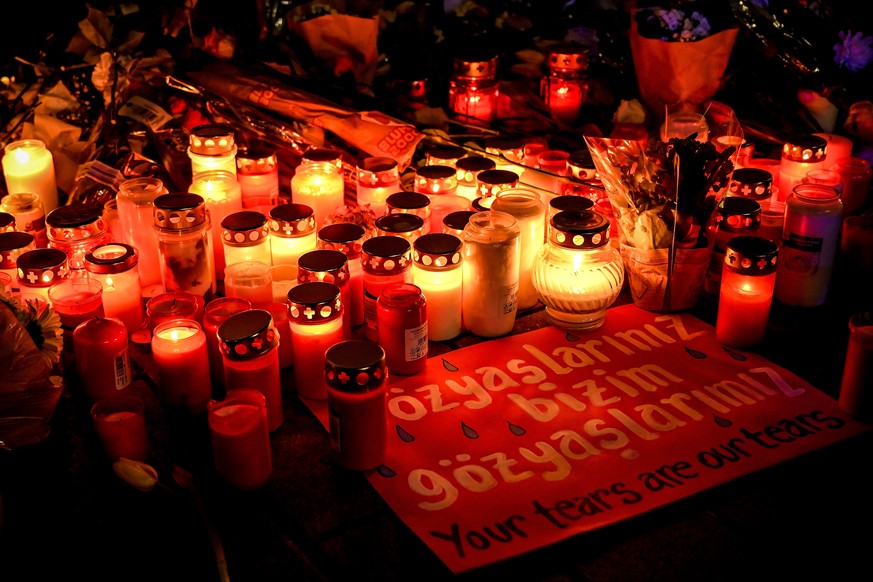 epa08232253 Flowers and candles are placed at the Brueder Grimm memorial in Hanau, Germany, 20 February 2020. At least nine people were killed in two shootings at shisha bars in Hanau, police said. Th ...