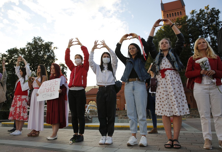 epa08632532 Belarus women show heart signs during a peaceful protest rally against the results of the presidential elections, in Minsk, Belarus 28 August 2020. Opposition protests in Belarus continue  ...