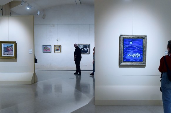 PARMA, ITALY - MARCH 18: Visitors admires the masterpieces part of the "Felice Casorati" exhibition about the work and life of italian artist Felice Casorati at Magnani Rocca Foundation on M ...