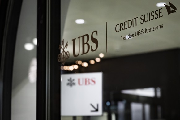 An advertising of the Swiss bank Credit Suisse reading in German "Part of the UBS Group", is pictured in a Swiss Bank UBS branch, in St. Moritz, Switzerland, Thursday, December 19, 2024. (KE ...
