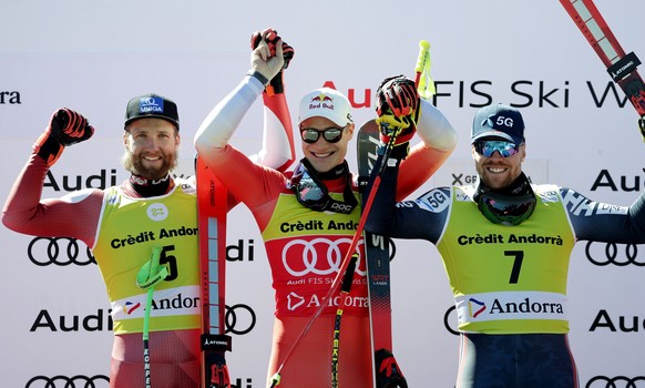 epa10526080 (L-R) Second placed Marco Schwarz of Austria, first placed Marco Odermatt of Switzerland and third placed Aleksander Aamodt Kilde of Norway pose on the podium after the Men&#039;s Super G  ...