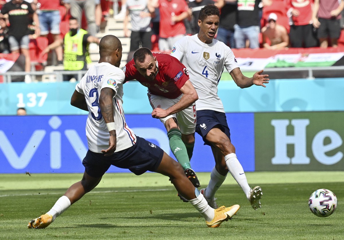 France's Raphael Varane, right, and France's Presnel Kimpembe, left, fail to stop Hungary's Attila Fiola from scoring his sides first goal during the Euro 2020 soccer championship group ...
