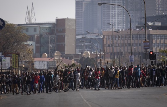 epa09336834 Supporters of ex President Jacob Zuma march through the streets during clashes in downtown Johannesburg, South Africa, 11 July 2021. President Zuma was arrested on Tuesday 06 July and sent ...