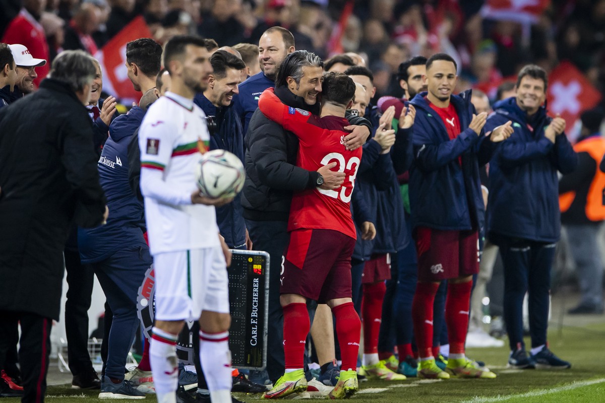Switzerland's head coach Murat Yakin celebrates the victory with Switzerland's midfielder Xherdan Shaqiri during the 2022 FIFA World Cup European Qualifying Group C match between Switzerland ...