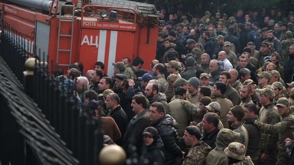 epa11723442 People protest outside the parliament building in Sukhumi, capital of the self-proclaimed Republic of Abkhazia, 15 November 2024. The opposition that seized the government building complex ...