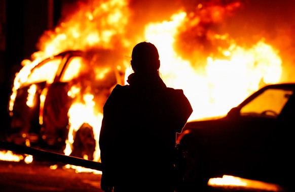 epa10384615 Firemen work to put out a fire from a burning car in Brussels during New Years Eve celebrations in Brussels, Belgium, 01 January 2023. Every year several cars burn in Brussels on New Years ...