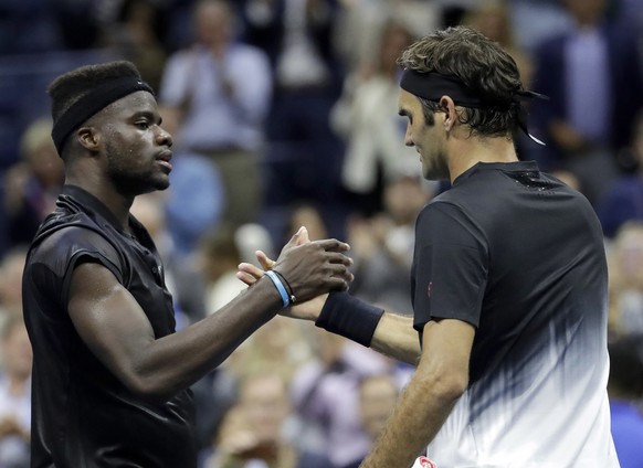 Roger Federer, right, of Switzerland, and Frances Tiafoe, of the United States, shake hands after Federer won their match at the U.S. Open tennis tournament, Tuesday, Aug. 29, 2017, in New York. (AP P ...