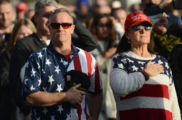 epa05732622 US president-elect Donald J. Trump supporters stand at attention while attending the Make America Great Again! Welcome Celebration at the Lincoln Memorial in Washington, DC, USA, 19 Januar ...