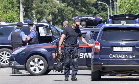 epa09267578 Carabinieri special unit officers take position in Ardea, near Rome, Italy, 13 June 2021. The man who allegedly shot and killed two brothers and an elderly person who was passing by bicycl ...