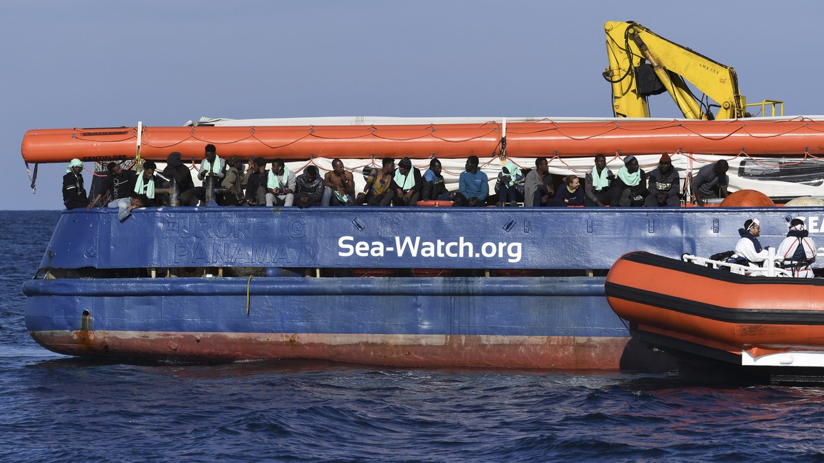 A coastguard boat approaches the German humanitarian group's rescue boat Sea Watch 3, to deliver food and blankets for the cold, off the coast of Syracuse, Italy, Sunday, Jan. 27, 2019. The Itali ...
