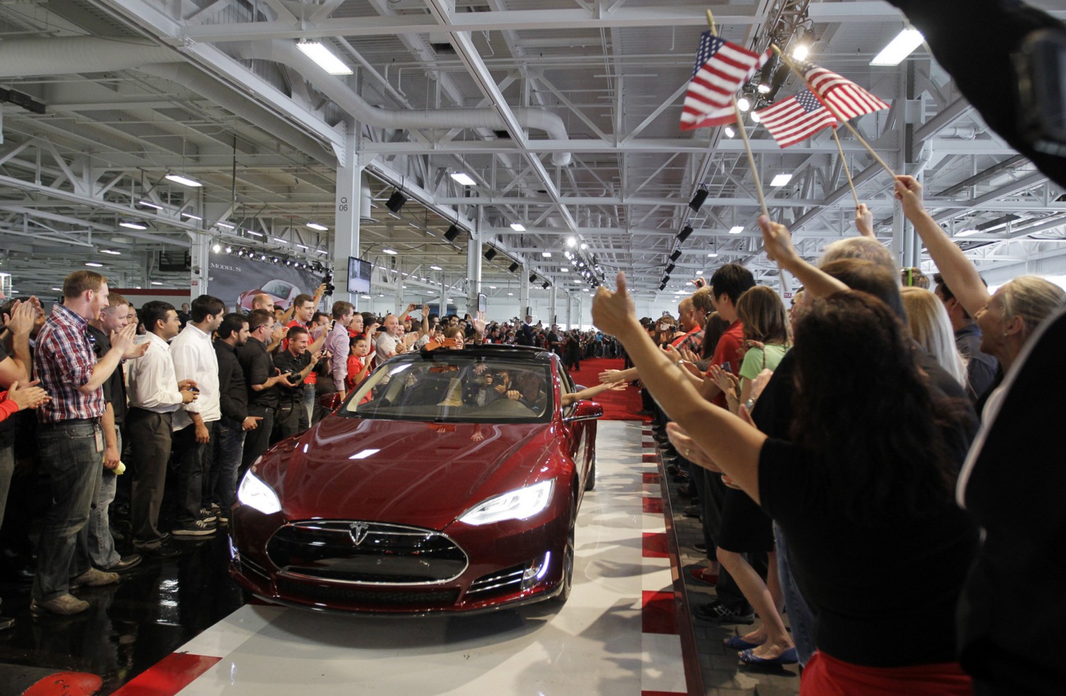 FILE - In this June 22, 2012 file photo, Tesla workers cheer on the first Tesla Model S cars sold during a rally at the Tesla factory in Fremont, Calif. The Tesla Motors Inc. Model S electric car has  ...