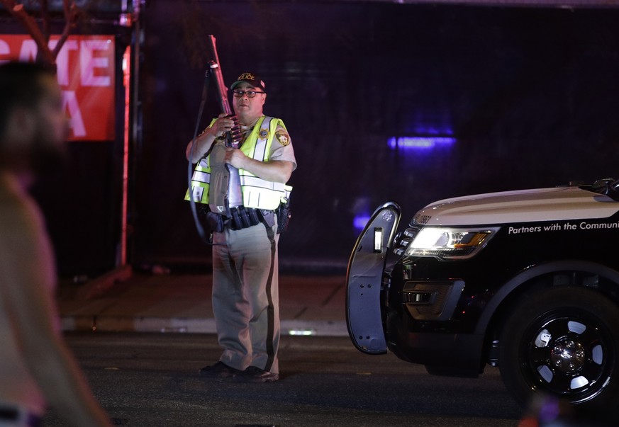 A police officer stands at the scene of a shooting along the Las Vegas Strip, Monday, Oct. 2, 2017, in Las Vegas. Multiple victims were being transported to hospitals after a shooting late Sunday at a ...
