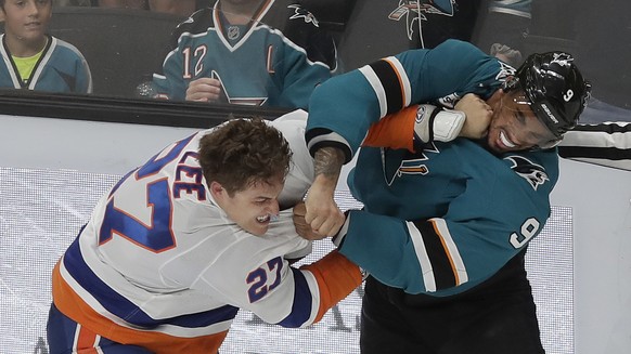 New York Islanders left wing Anders Lee, left, fights with San Jose Sharks left wing Evander Kane during the third period of an NHL hockey game in San Jose, Calif., Saturday, Oct. 20, 2018. The Sharks ...