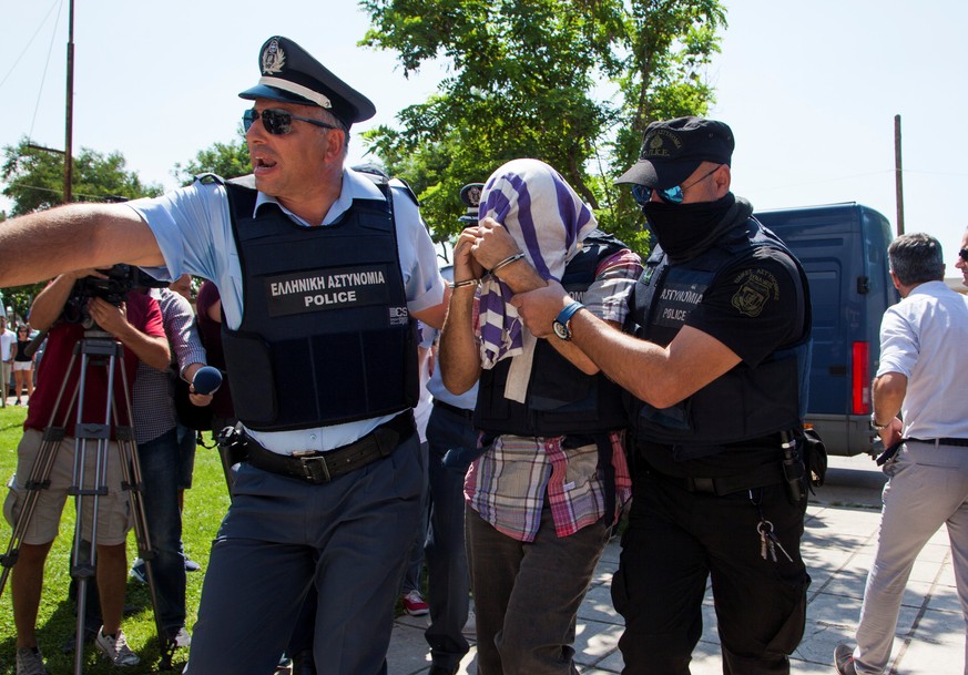 One of the eight Turkish soldiers who fled to Greece in a helicopter and requested political asylum after a failed military coup against the government, is escorted to the courthouse of the northern c ...