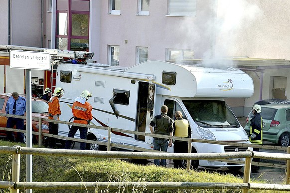 FILE - In this Nov. 4, 2011 file photo firefighters and police officer stand close to a camper van in Eisenach, eastern Germany, in which the bodies of Uwe Boehnhardt and Uwe Mundlos have been found.  ...