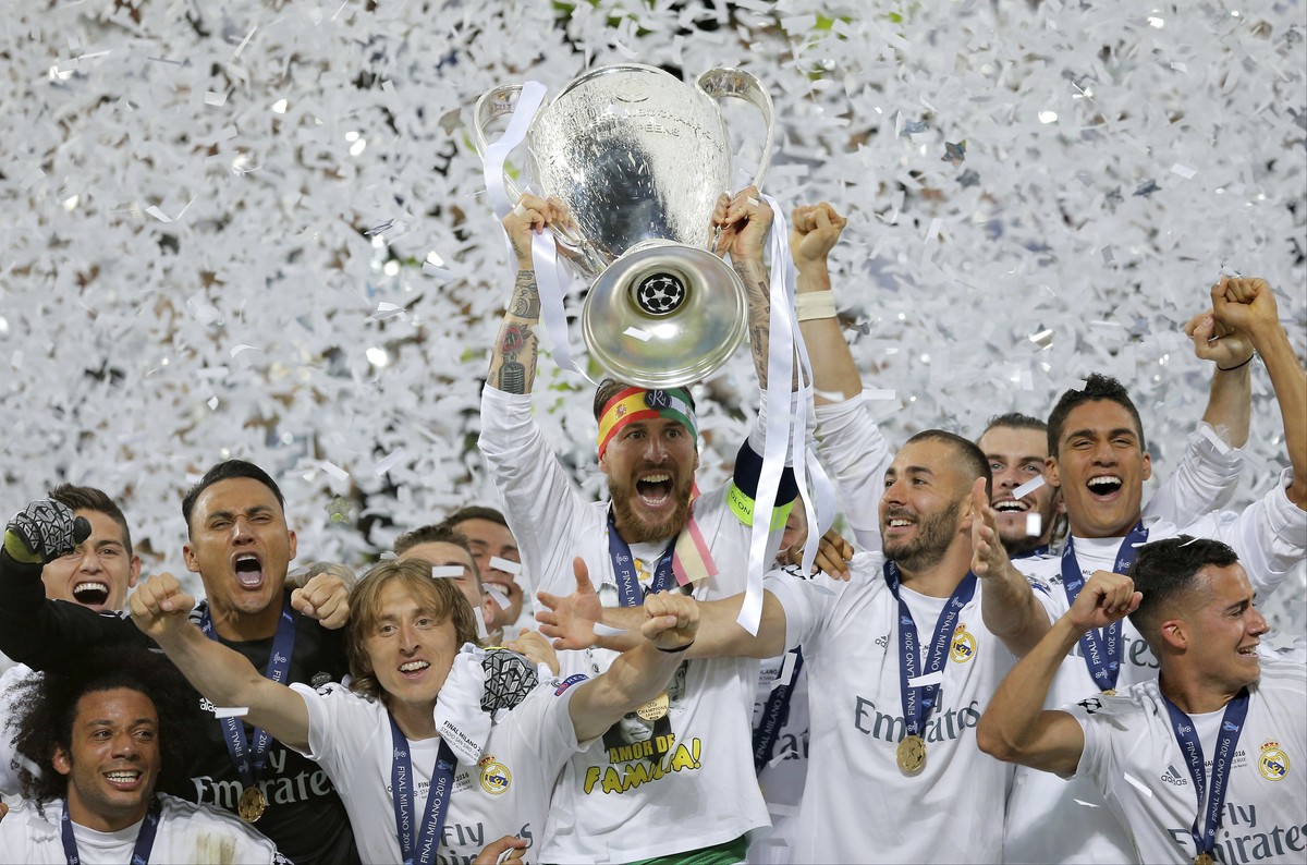 FILE - In this May 28, 2016 fiel photo, Real Madrid's Sergio Ramos raises the trophy after the Champions League final soccer against Atletico Madrid at the San Siro stadium in Milan, Italy. An em ...