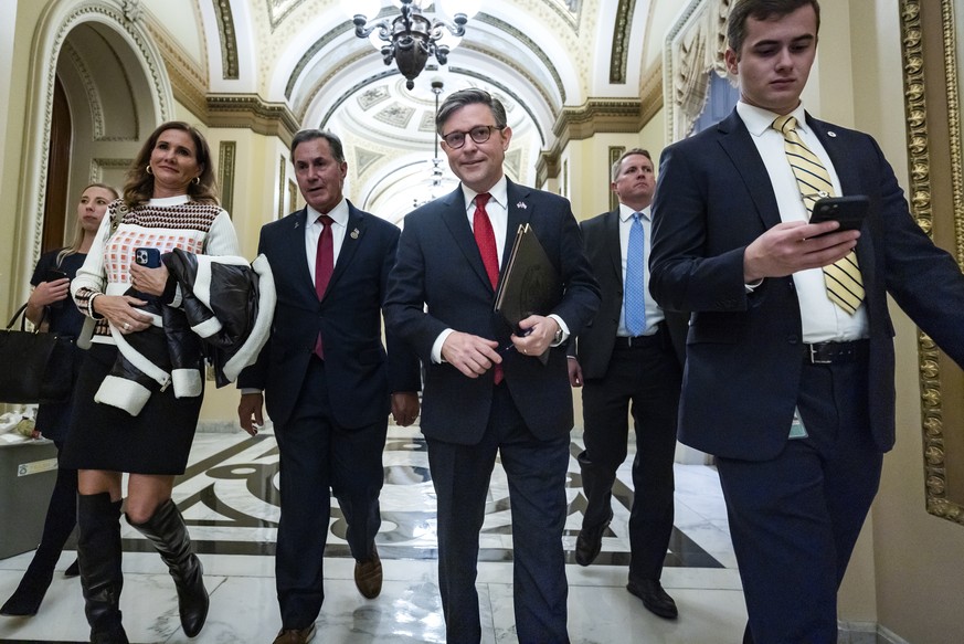 epa10975503 Republican Speaker of the House Mike Johnson (C) walks off the House floor after the House passed his two-tier continuing resolution (CR) to keep the US government from shutting down in th ...