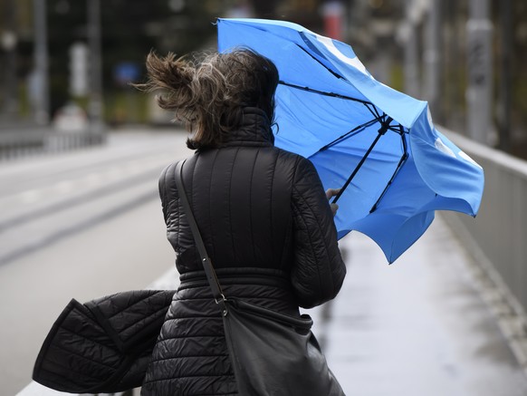 A woman with an umbrella in the wind during the storm Ciara in Bern, Switzerland, Monday, February 10, 2020. Western and northern Europe braces for storm Ciara that is expected to bring strong winds a ...