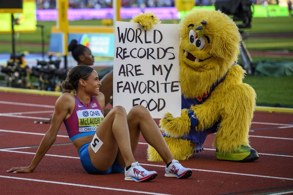 epa10087348 Gold medalist Sydney McLaughlin of the US reacts with the championships mascot Bigfoot after winning the women's 400m Hurdles final in a new world record time at the World Athletics Champi ...