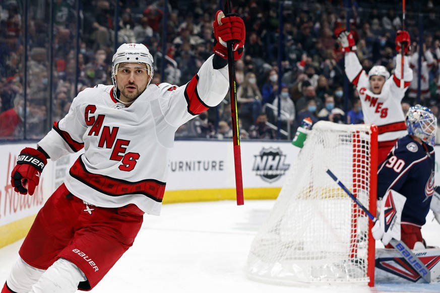 Carolina Hurricanes&#039; Nino Niederreiter, left, celebrates his goal against Columbus Blue Jackets&#039; Elvis Merzlikins during the third period of an NHL hockey game Saturday, Jan. 1, 2022, in Col ...