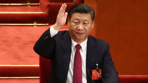 epa06285290 Chinese President and General Secretary of the Communist Party of China Xi Jinping raises hand to take a vote during the closing ceremony of the 19th National Congress of the Communist Par ...