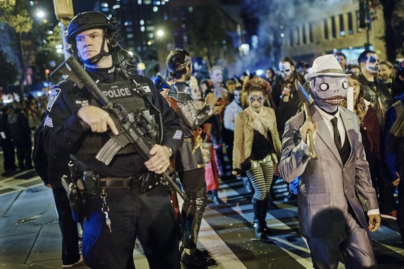 Heavily armed police guard as revelers march during the Greenwich Village Halloween Parade, Tuesday, Oct. 31, 2017, in New York. New York City&#039;s always-surreal Halloween parade marched on Tuesday ...