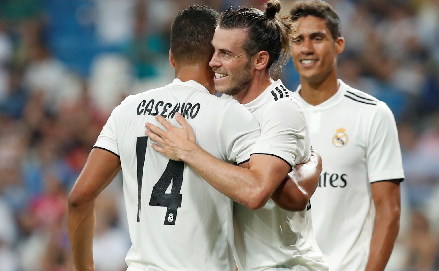 epa06944630 Real Madrid´s Welsh forward Gareth Bale (C) celebrates with Brazilian Casemiro (L) after scoring against Milan during the Santiago Bernabeu trophy match against Milan played at the Santiag ...