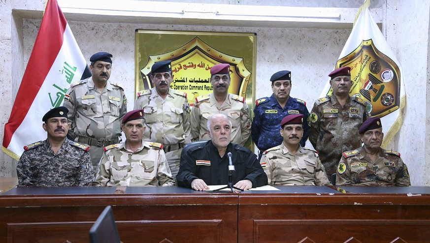 This photo released on his official Facebook page shows Iraqi Prime Minister Haider al-Abadi, center, surrounded by top military and police officers as he announces the start of the operation to liber ...