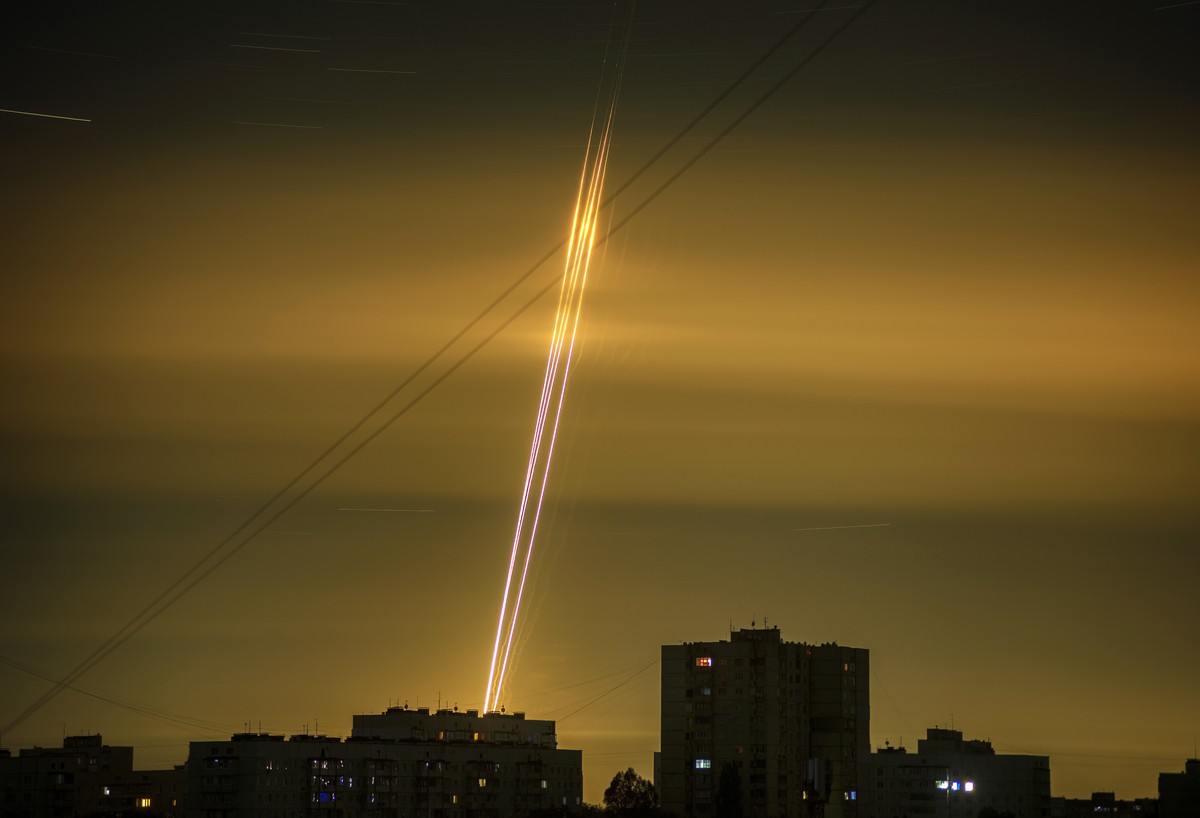 Russian rockets launched against Ukraine from Russia's Belgorod region are seen at dawn in Kharkiv, Ukraine, early Saturday, Sept. 3, 2022. (AP Photo/Vadim Belikov)