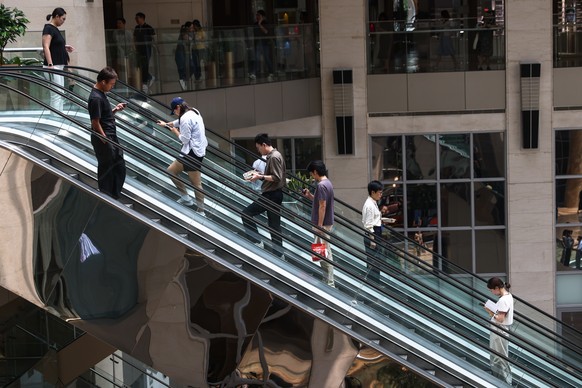 epa12230898 People take an escalator at a mall in Beijing, China, 11 July 2025. According to the United Nations Population Fund (UNFPA), China&#039;s population decreased to 1,416.1 millions in 2025,  ...